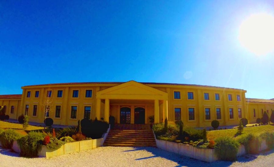 front view of 'Ktima Karipidis' building with four columns at entrance and a staircase